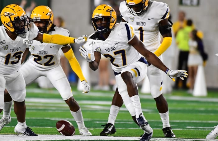 Sep 21, 2019; Fort Collins, CO, USA; Toledo Rockets defensive back Kahlil Robinson (27) reacts to his interception with cornerback Chris McDonald (13) and (22)cornerback Jordan Hendy (22) and defensive back Tycen Anderson (1) in the second quarter against the Colorado State Rams at Sonny Lubrick Field at Canvas Stadium. Mandatory Credit: q